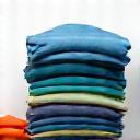 Icono de prendas de ropa siendo clasificadas por un profesional, representando la meticulosa separación por colores y tejidos.